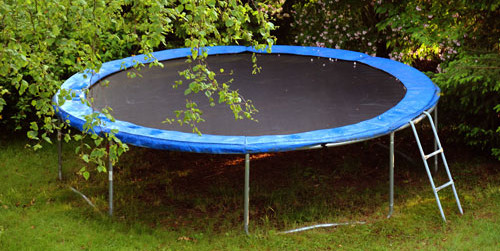 Black and blue trampoline outside. Trampoline Removal Services in Vancouver WA by Mike & Dad's Hauling