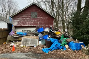 A pile of junk outside of a garage in Vancouver, WA. Contact Mike & Dad's Hauling to get rid of your junk.